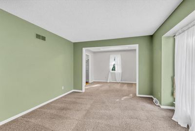 Unfurnished room featuring a textured ceiling and light carpet | Image 3