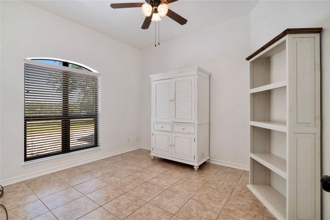 Unfurnished bedroom featuring ceiling fan and light tile patterned floors | Image 18