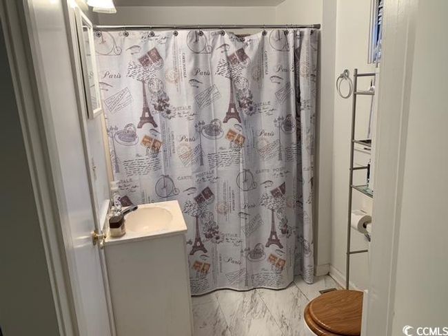 Full bathroom featuring vanity, marble look tile flooring, a shower with curtain, and toilet | Image 19