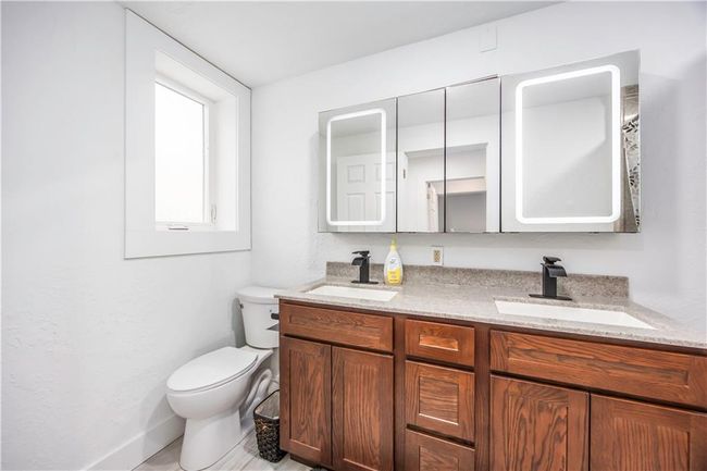 Bathroom with a sink, toilet, and double vanity | Image 47