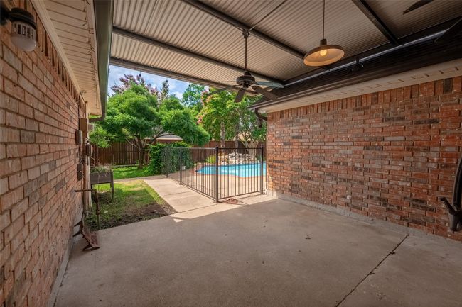 Fenced backyard featuring ceiling fan and a patio | Image 25