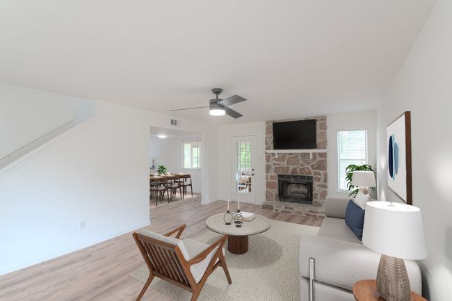 The living room features a gas fireplace and tall ceilings. | Image 6