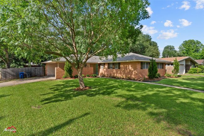 Ranch-style home featuring concrete driveway, brick siding, and an attached carport | Image 23