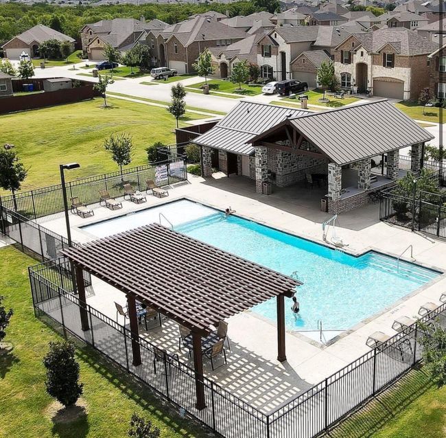 Pool with a yard, fence, a residential view, and a patio area | Image 38