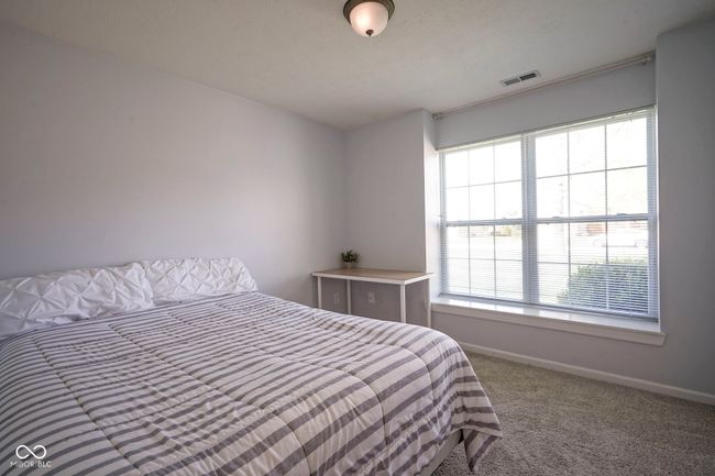bedroom featuring carpet flooring, visible vents, multiple windows, and baseboards | Image 27