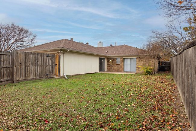 Rear view of house featuring a patio and a chimney | Image 24