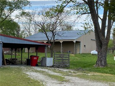 View of front of house with a front yard and a garage with car lift. | Image 2