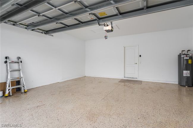 Garage with a garage door opener and water heater | Image 28