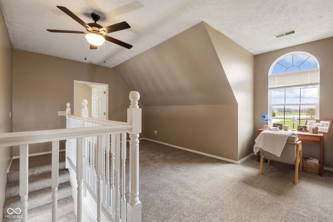 interior space with visible vents, baseboards, a ceiling fan, carpet, and vaulted ceiling | Image 21