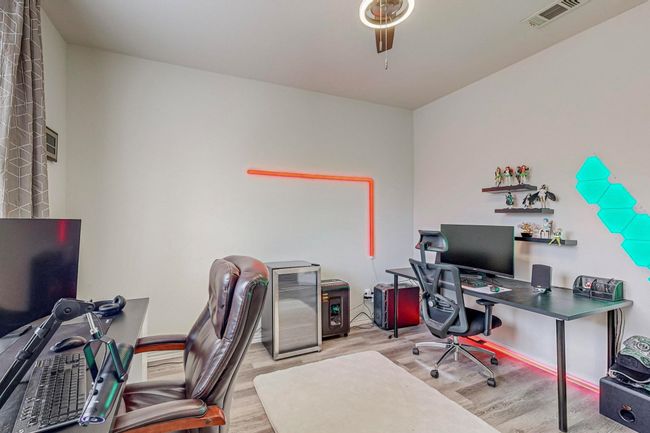 Home office with wood finished floors, ceiling fan, and baseboards | Image 21