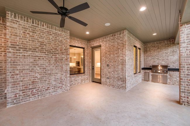 View of patio / terrace with exterior kitchen and a ceiling fan | Image 6