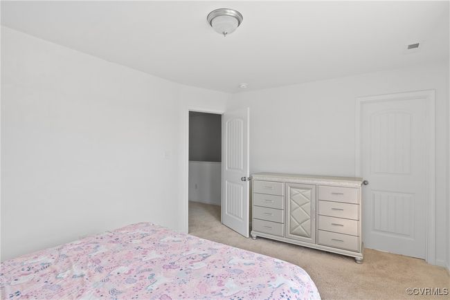 Bedroom featuring visible vents and light colored carpet | Image 27