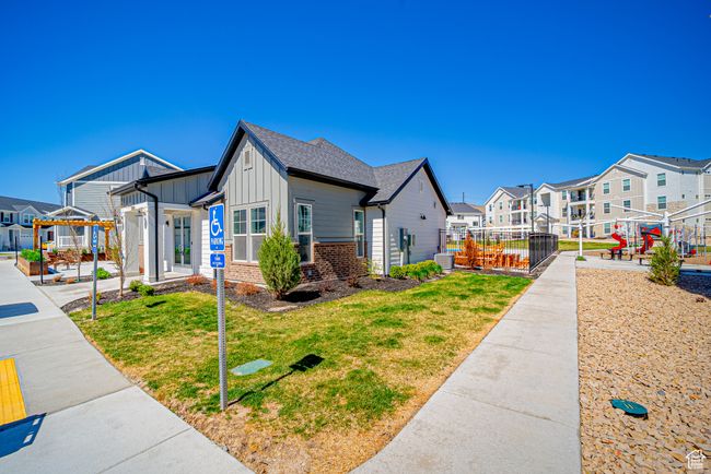 View of side of home with a residential view, a pergola, board and batten siding, a yard, and fence | Image 25