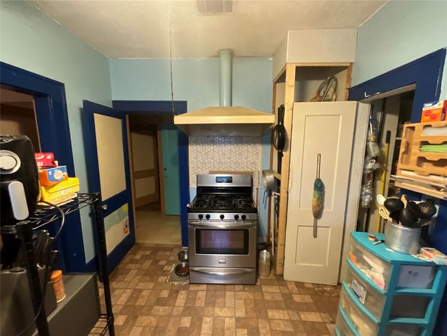 Kitchen featuring stainless steel gas stove and extractor fan | Image 6