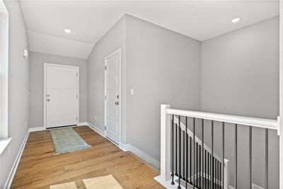 Foyer entrance featuring light hardwood / wood-style floors and lofted ceiling | Image 3