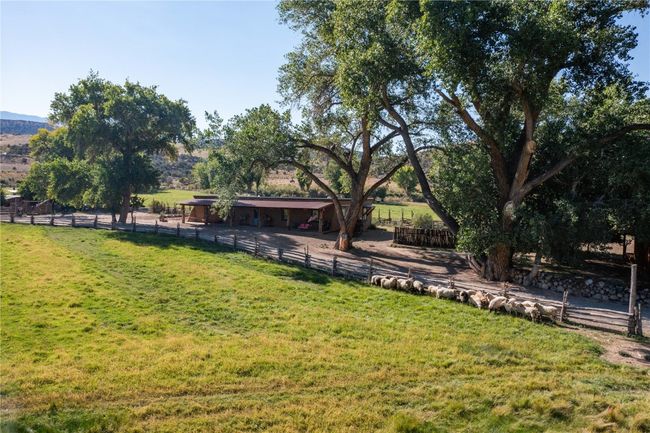 View of yard with a rural view, fence, an exterior structure, and an outdoor structure | Image 8