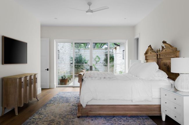 Bedroom with wood finished floors, ceiling fan, and access to exterior | Image 17