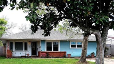 Home includes 2 living rooms, 2 kitchens, covered and enclosed porch, 3 car garage, Roof is only 2 years old . | Image 2