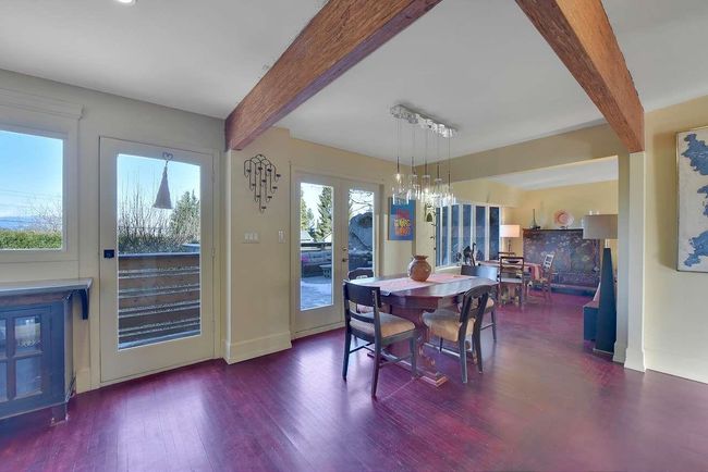 Dining area featuring beam ceiling, wood finished floors, and french doors | Image 12