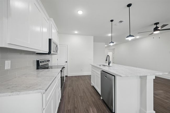 Kitchen with a sink, a ceiling fan, stainless steel appliances, visible vents, and dark wood-type flooring | Image 10