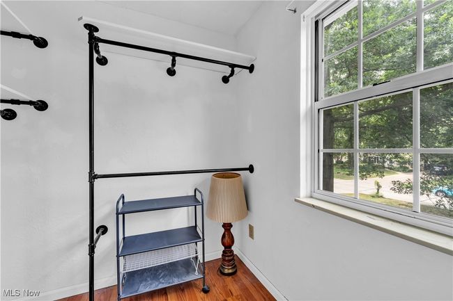 PRIMARY BEDROOM WALK IN CLOSET - YOU'LL FIND FULL WALK UP ATTIC STAIRS FOR CONVENIENT ACCESSIBILITY FOR STORAGE | Image 18