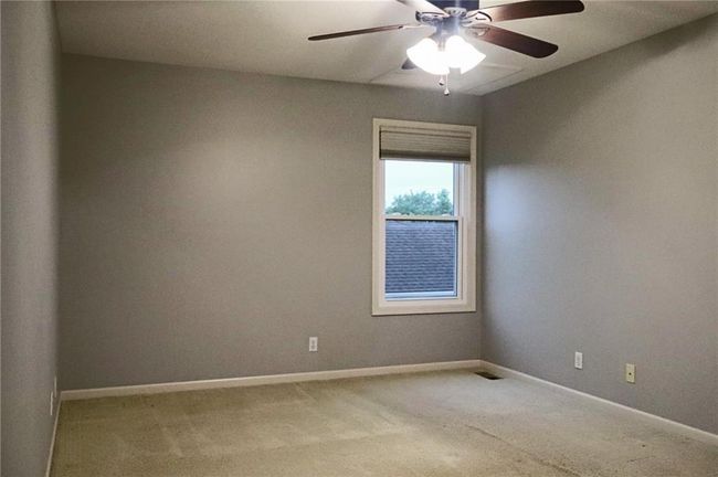 Carpeted empty room featuring baseboards and a ceiling fan | Image 12