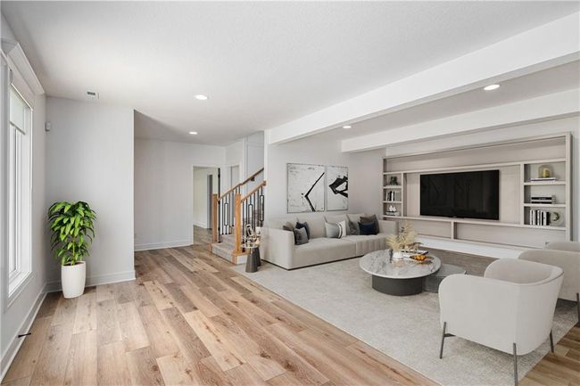 Living room with light wood-style floors, recessed lighting, stairs, and baseboards | Image 52