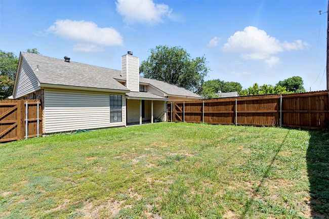 View of fenced backyard | Image 23