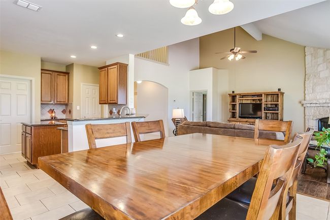 Dining area featuring light tile patterned flooring & is off of the kitchen & living room. | Image 19