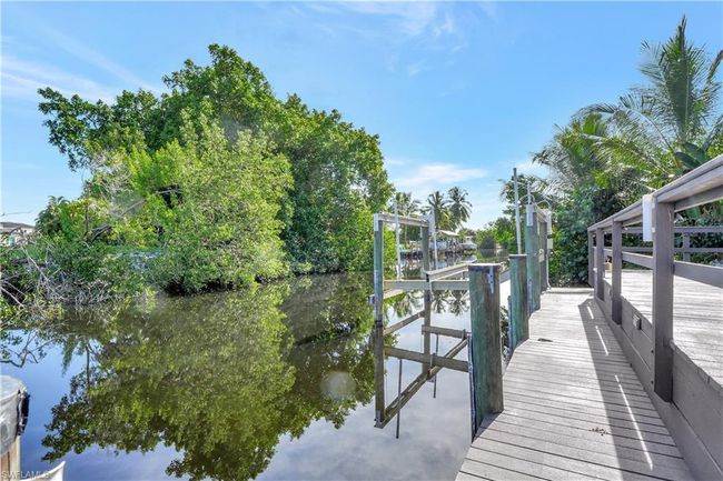 Dock area with a water view and boat lift | Image 32