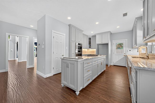 Kitchen with gas cooktop in Island and hidden Pop-Up TV, can you find it? | Image 16