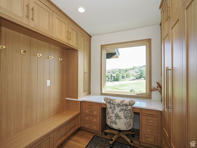 Office space featuring built in study area, dark wood-style flooring, and recessed lighting | Image 43