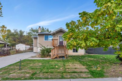 View of front of house featuring a front yard and a shed | Image 2