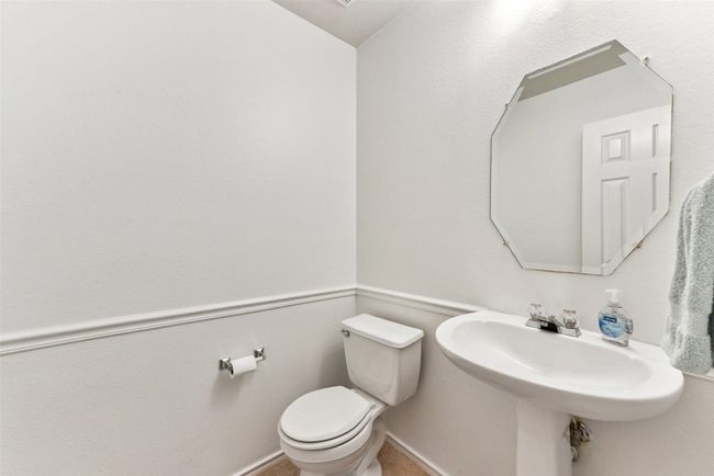 Half bathroom with large tile in hallway | Image 11