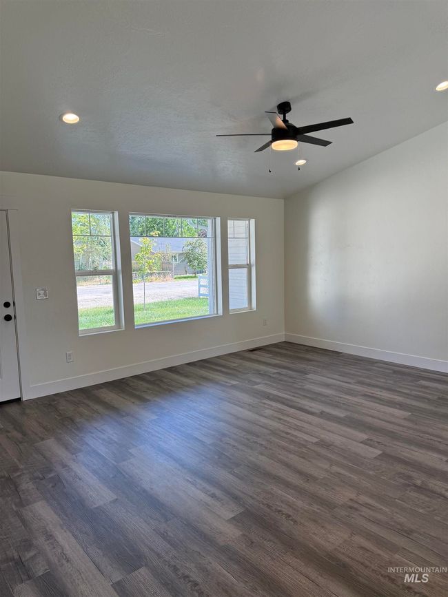 Spare room with dark wood-style floors, ceiling fan, and recessed lighting | Image 4
