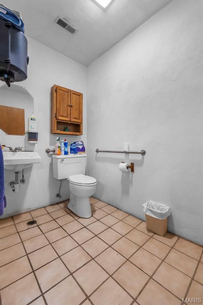 Bathroom featuring toilet and tile patterned floors | Image 49