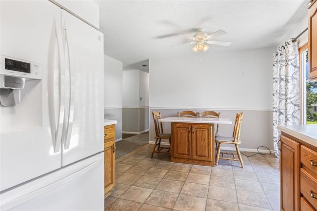 Dining area with ceiling fan, baseboards, and a textured ceiling | Image 37