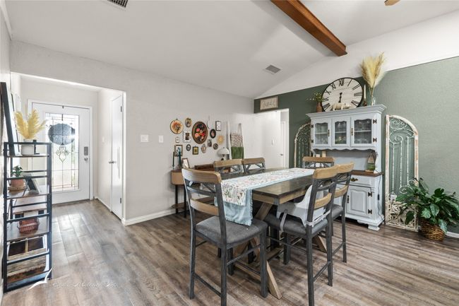 Dining area featuring visible vents, lofted ceiling with beams, baseboards, and wood finished floors | Image 4