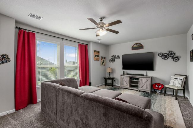 Living room featuring baseboards, a ceiling fan, and carpet | Image 16