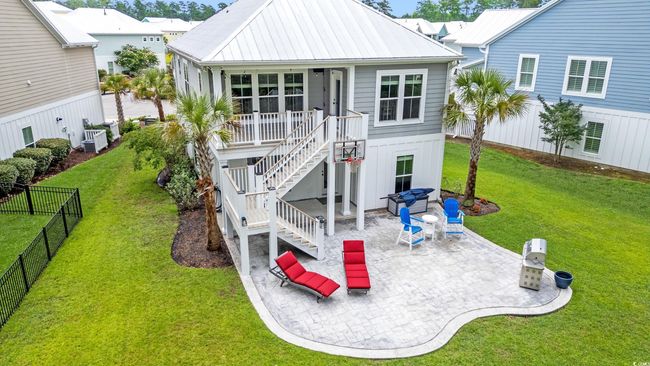 Back of house with stairway, a patio area, a metal roof, and covered porch | Image 21