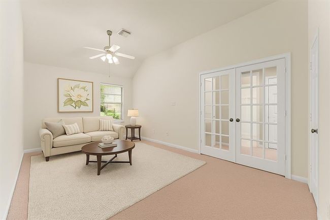 Tucked just off the primary suite with a double door entrance, this expansive bonus room offers endless flexibility - perfect as a private sitting area, nursery, fitness space, or second office. virtually staged | Image 22