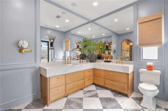 Bathroom with toilet, double vanity, and visible vents | Image 25