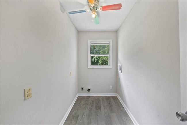 Washroom with hookup for a washing machine, baseboards, wood finished floors, laundry area, and a ceiling fan | Image 54