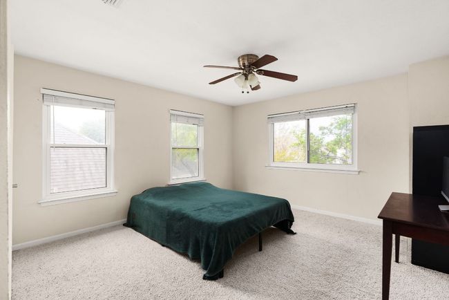 Bedroom featuring carpet flooring, baseboards, and a ceiling fan | Image 21