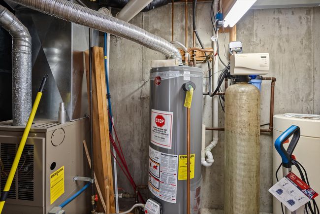 Utility room featuring gas water heater and heating unit | Image 41