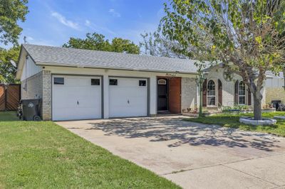 View of front facade with a front lawn and a garage | Image 3