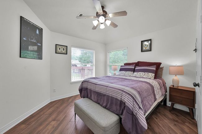 Bedroom 2 is located in the back corner of the home, offering beautiful views of the balcony, pool, and golf course. | Image 27