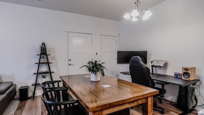 Office space with wood finished floors and a chandelier | Image 10