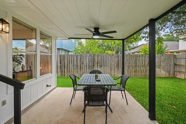 Enjoy year-round outdoor living on the covered patio, complete with a ceiling fan for added comfort. 9349 Bernoulli Dr., Austin, TX 78748 | Image 29