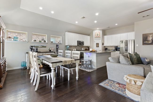 Dining space featuring dark wood-type flooring, visible vents, and recessed lighting | Image 14